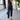 Beige sleeveless belted jumpsuit displayed on a hanger against a neutral backdrop, highlighting its casual chic style perfect for summer outings.