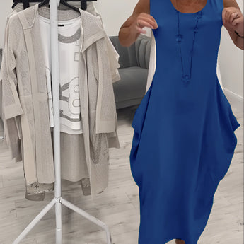 Beige sleeveless linen midi dress designed for elegant and casual summer fashion, featuring a one-piece garment style. The dress highlights a classic neckline and is suitable for daytime wear.