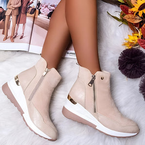 Beige suede ankle boots with gold accents, featuring a white sole and a front zipper, displayed in size 43.