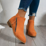 Beige suede women's ankle boots with a low heel, featuring a side zipper and a burnt orange hue, ideal for casual wear with denim or dress attire.