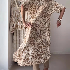 Beige Swirl Kimono Cardigan worn by a model with flowing sleeves and chic swirl pattern, showcasing its elegant and casual style as a versatile cover-up.
