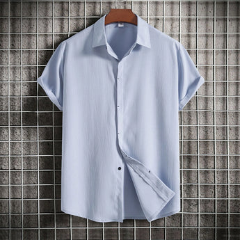 Light blue textured Cuban collar men's summer shirt in size 3XL, displayed on a clothes hanger with short sleeves and buttoned front.