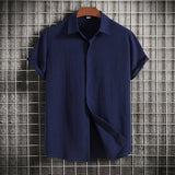 Men's short-sleeve summer shirt in marine blue with a Cuban collar and button-up front, designed for a lightweight and breathable fit.