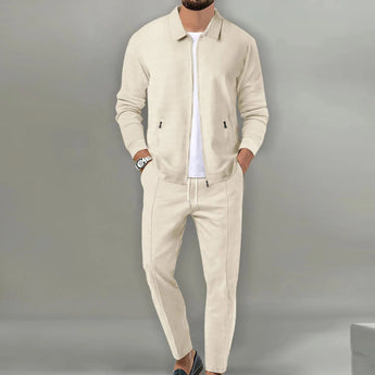 A man wearing a beige textured lightweight tracksuit, consisting of a jacket and joggers, size 3XL.