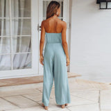 Sleeveless beige jumpsuit with a tie-waist design, featuring a casual yet elegant style suitable for summer wear.