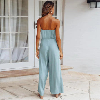 Sleeveless beige jumpsuit with a tie-waist design, featuring a casual yet elegant style suitable for summer wear.