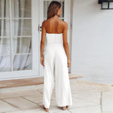 Beige tie-waist sleeveless jumpsuit featuring a fitted waist, sleeveless design, and elegant casual style suitable for summer wear.