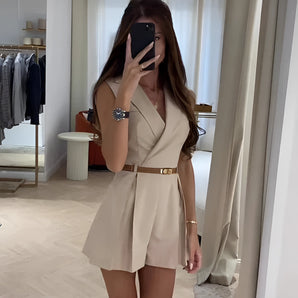 Beige sleeveless V-neck romper with a belted waist, designed for women's summer fashion.