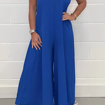 Blue V-neck wide-leg jumpsuit with short sleeves and a fitted waist, styled for an elegant formal summer look.