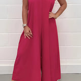 Elegant formal summer chic jumpsuit featuring a pink color in size 2XL, designed with a v-neckline, wide-leg cut, and sleeveless style, suitable for formal occasions.
