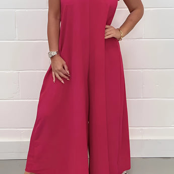 Elegant formal summer chic jumpsuit featuring a pink color in size 2XL, designed with a v-neckline, wide-leg cut, and sleeveless style, suitable for formal occasions.