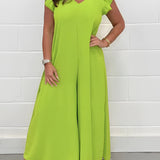 Beige V-neck wide-leg jumpsuit in yellow green color, featuring a chic and elegant design suitable for formal summer occasions, with a focus on the arm, shoulder, and neck details.