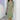 
A knee-length formal dress in a beige wave pattern, designed for office wear, featuring short sleeves and a fitted waist. The dress is styled with a round neckline and falls gracefully to the knees.