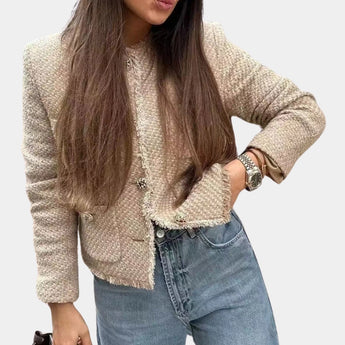 Beige women's bouclé double-breasted blazer worn by a model, showcasing chic fall outerwear fashion.