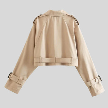 Beige women's cropped jacket featuring belted sleeves and a high collar, designed in a stylish and modern fashion.