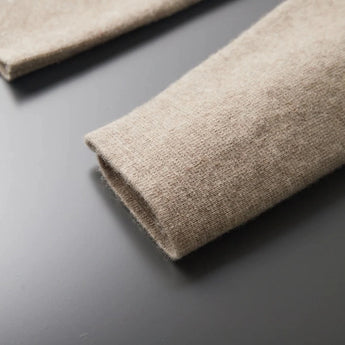 Beige women's collarless open front linen blazer displayed on a grey wooden flooring background.