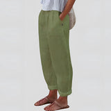 Beige women's linen pants with an elastic waist, shown in a green variant in size 3XL. The image features a model wearing the lightweight and sustainable pants, showcasing their relaxed fit and comfortable style.