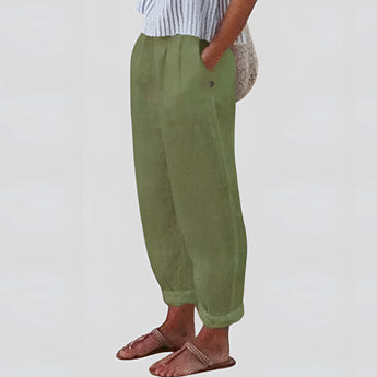 Beige women's linen pants with an elastic waist, shown in a green variant in size 3XL. The image features a model wearing the lightweight and sustainable pants, showcasing their relaxed fit and comfortable style.