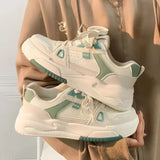 Beige women's low-top fashion sneakers crafted from textured fabric with a durable sole, shown in green color for size 40.