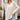 Beige women's oversized batwing poncho sweater in XL, modeled with sunglasses, showcasing fall fashion with a focus on the shoulder and neck areas.