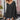 Black oversized batwing poncho sweater for women in XL, featuring a loose fit and comfortable style, perfect for fall fashion. The model is accessorized with sunglasses and showcases the garment's elegant drape over the shoulders.