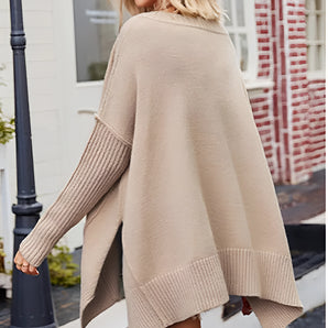 Beige women's oversized batwing poncho sweater worn by a woman in fall fashion, accessorized with sunglasses and stylish shoes, highlighting the casual and trendy outerwear look.