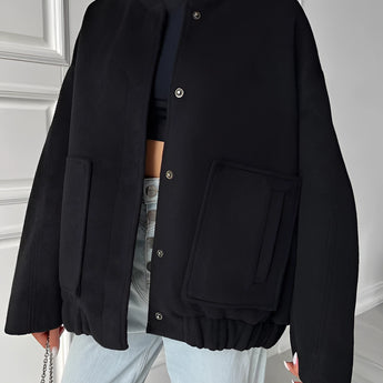 Beige women's oversized fleece bomber jacket, showcasing trendy winter fashion with a warm and cozy design, featuring long sleeves and a comfortable fit.