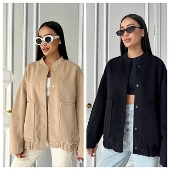 Beige women's oversized fleece bomber jacket displayed on a model, featuring long sleeves and a cozy design, perfect for trendy winter fashion.