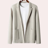 Beige women's oversized wool blazer with a notch lapel, featuring long sleeves, buttons, and a formal design.