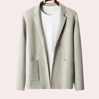 Beige women's oversized wool blazer with a notch lapel, featuring long sleeves, buttons, and a formal design.