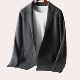 Dark gray oversized wool blazer for women, featuring a notch lapel collar and long sleeves, suitable for autumn wear in a formal or fashionable context.