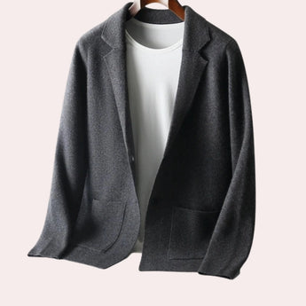 Dark gray oversized wool blazer for women, featuring a notch lapel collar and long sleeves, suitable for autumn wear in a formal or fashionable context.