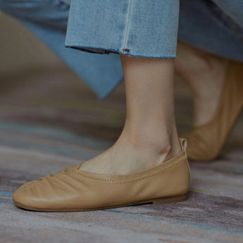 Beige women's soft leather ballet flats showcasing flexible slip-on design with a smooth finish, ideal for casual wear.