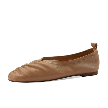 Beige women's soft leather ballet flats, flexible slip-on shoes with a simple and elegant design, displayed on a wooden surface.
