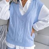 Beige women's V-neck cable knit vest in a casual preppy style, designed for layering. The vest is shown over a white dress shirt, highlighting its versatility and fashion-forward appeal.