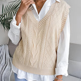 Beige women's V-neck cable knit vest layered over a white dress shirt, showcasing a casual preppy style. The vest features a classic cable knit pattern, designed for comfortable and stylish layering.