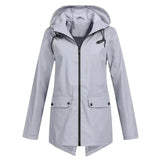 Gray women's waterproof hooded raincoat in size 2XL, featuring a lightweight and stylish design with long sleeves, a collar, buttons, and pockets.