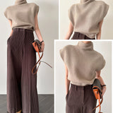 Beige wool blend sleeveless turtleneck sweater on a hanger, showcasing its high neckline and soft fabric texture, suitable for women's winter fashion.