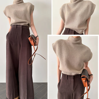Beige wool blend sleeveless turtleneck sweater on a hanger, showcasing its high neckline and soft fabric texture, suitable for women's winter fashion.