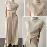 Beige wool blend sleeveless turtleneck sweater for women, showcasing winter fashion with a soft and cozy design, featuring a high neck and tailored fit.