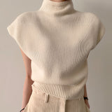 Sleeveless beige wool blend turtleneck sweater for women, showcasing winter fashion with a cozy design and elegant silhouette, featuring a high neck and soft texture.