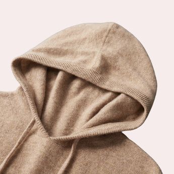 Beige wool cowl neck sweater with long sleeves, displayed on a mannequin, emphasizing comfort and elegance in women's winter knitwear.