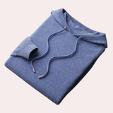 Woman wearing a blue cowl neck sweater with long sleeves and a relaxed fit, designed as elegant winter knitwear in an XL size.