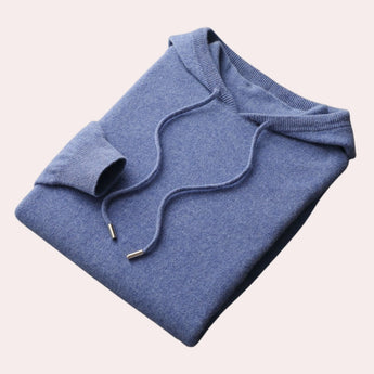 Woman wearing a blue cowl neck sweater with long sleeves and a relaxed fit, designed as elegant winter knitwear in an XL size.