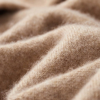 Beige wool cowl neck sweater for women displayed on a wooden background, showcasing its elegant knit pattern and warm winter design.
