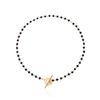 Minimalist black bead choker necklace featuring a gold bird pendant, perfect for nature-inspired fashion.