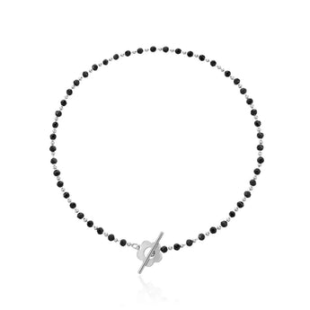 Black bead choker necklace with a gold bird pendant, minimalist nature jewelry in silver color, displayed on a neutral background.