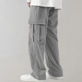 Black corduroy cargo pants made of durable cotton with a soft drawstring, featuring multiple pockets and a relaxed fit around the waist and knees.