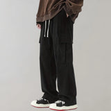 Black corduroy cargo pants made of durable cotton with a soft drawstring, designed for a comfortable fit.
