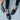 Black crocodile loafers for women, luxury designer slip-on shoes, black color, size 43, modeled with grey denim jeans, standing position.